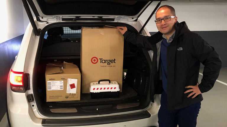 Mitsui Human Resource Advisor, Jerry Wang packing the car with donated toys and books bound for the Smith Family Christmas Appeal. 
